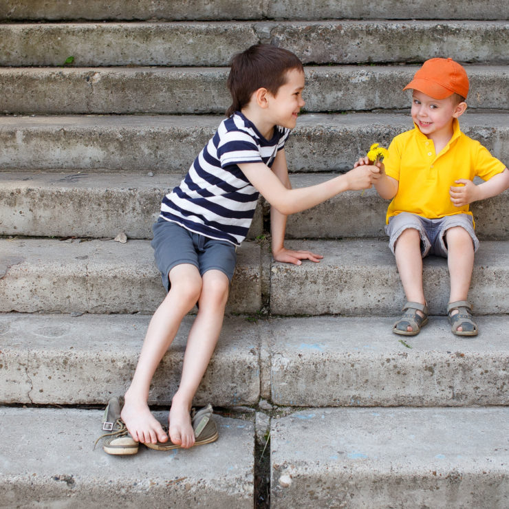 Older Child Sharing With A Younger Child