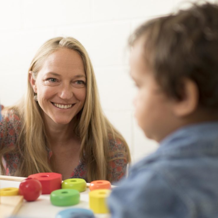 Center faculty Sarah Short playing with a child.