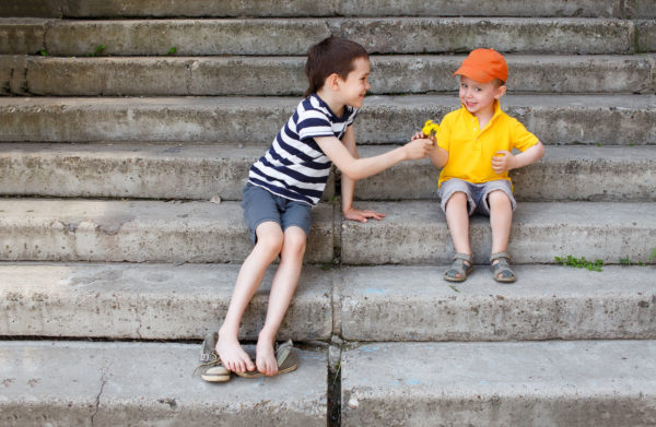 Older Child Sharing With A Younger Child