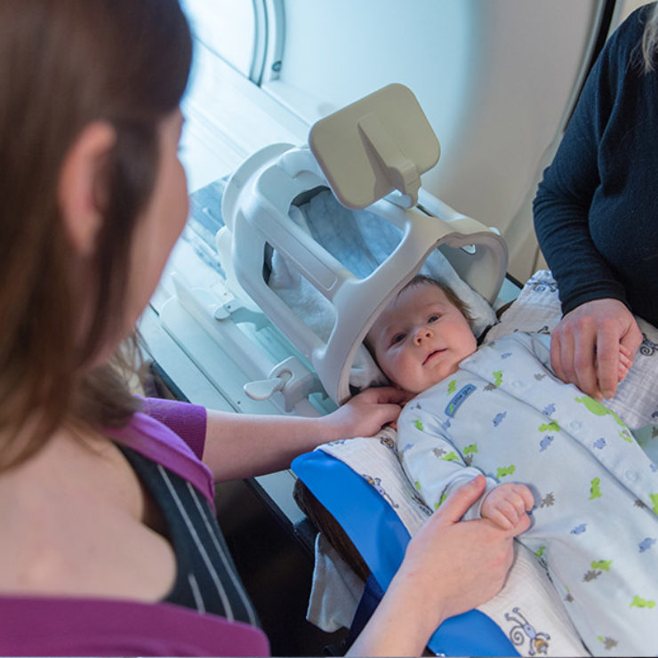 Mother and Center staff with infant for Baby Brain and Behavior Project