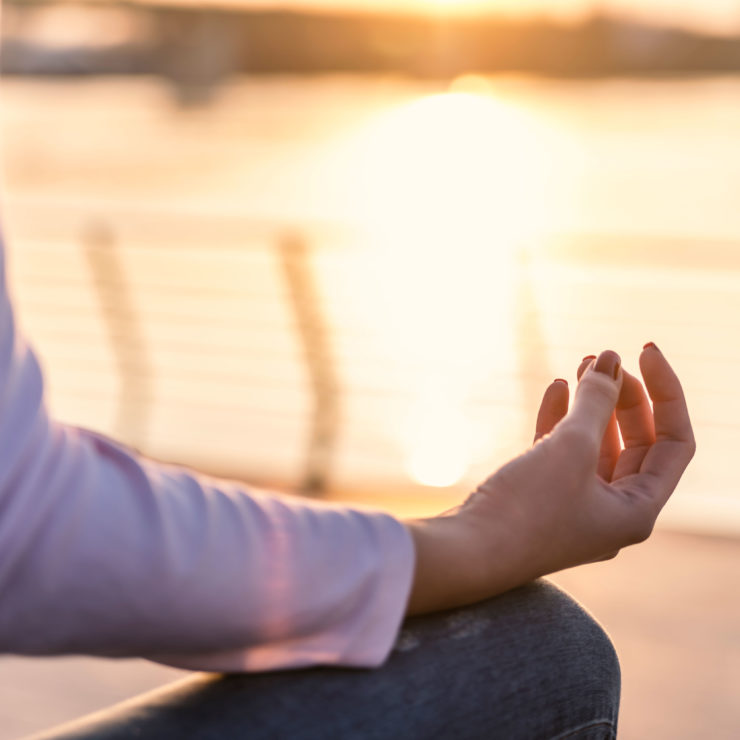 Person Sitting In The Sunlight Meditating