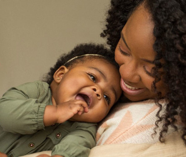 African American Mother Holding Baby To Demonstrate The Importance Of Healthy Infant Mother Relationships