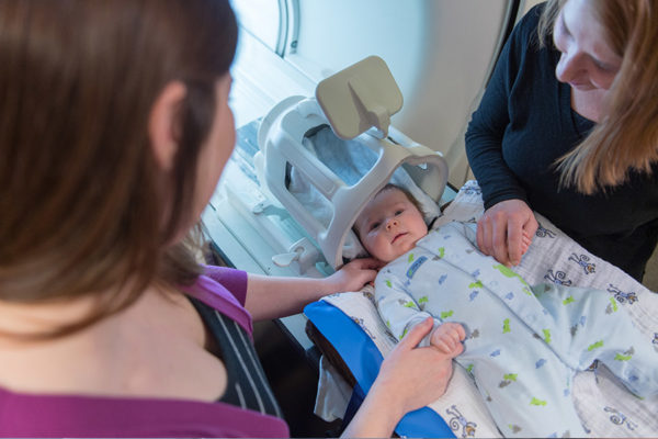 Mother and Center staff with infant for Baby Brain and Behavior Project