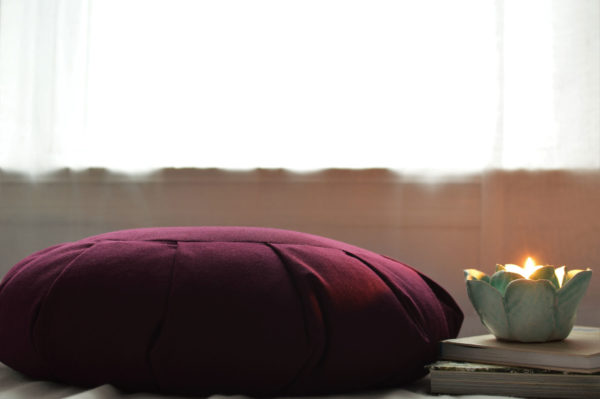 Meditation Cushion Next To Candle