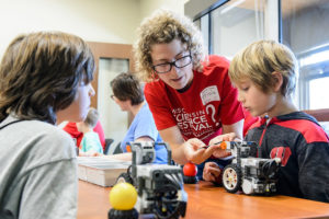 Photo of woman interacting with children at science festival by Bryce Richter from University Communications