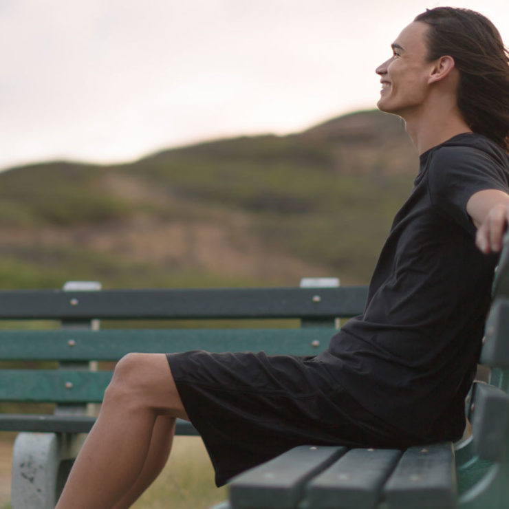 Young Man On A Park Bench Smiling