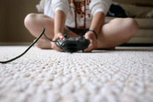 Photo of child playing a video game by Chapendra from Flickr